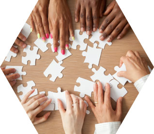 photo - closeup of multiple people working together on a puzzle