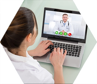 photo - a woman looking at a laptop where a doctor is seen speaking onscreen
