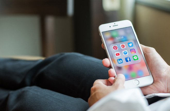 photo – closeup of a phone with social media icons